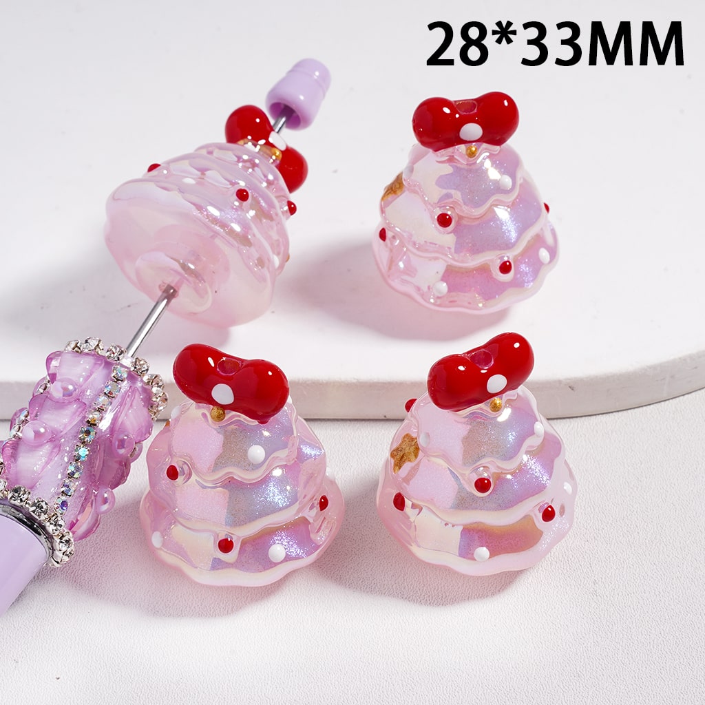 Pink and red decorative beads with a bow on a white background

