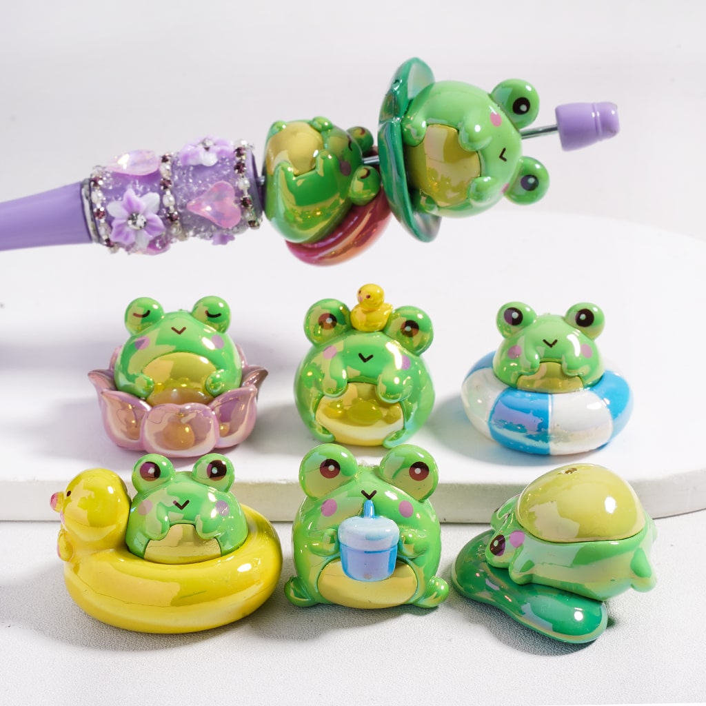 Set of colorful frog-shaped toys on a white background