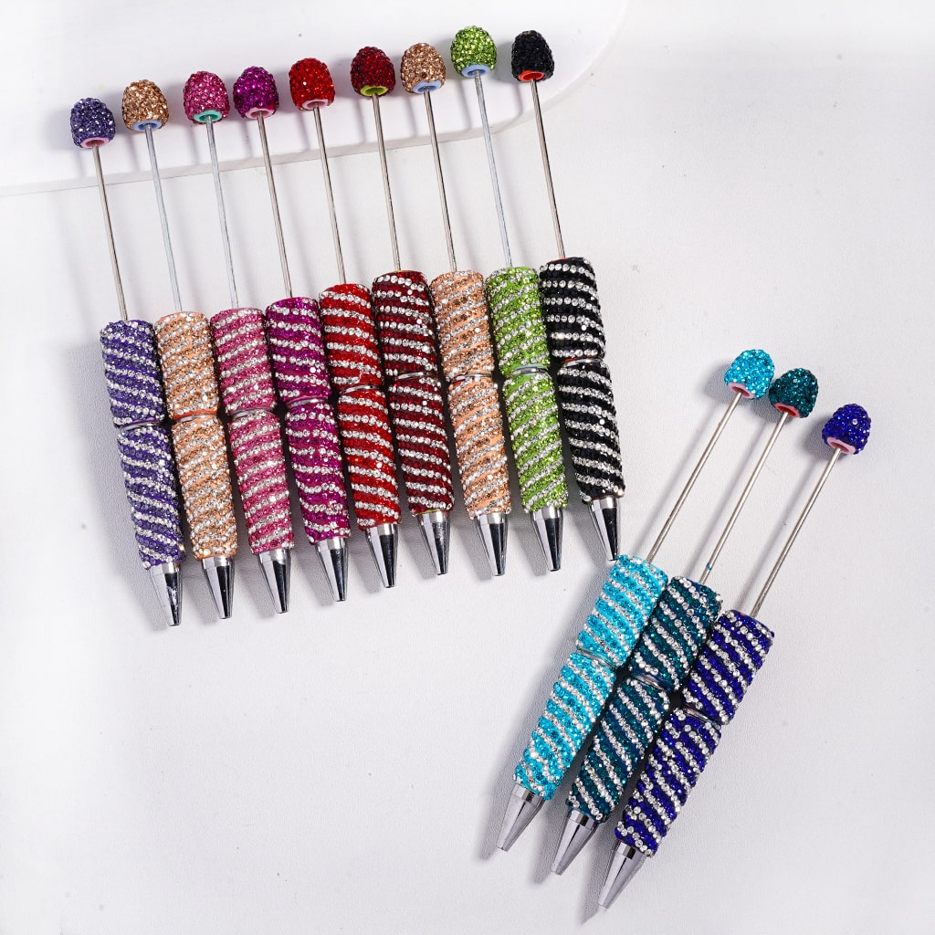 Set of colorful rhinestone-studded sticks on a white background

