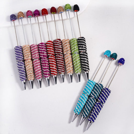 Set of colorful rhinestone-studded sticks on a white background

