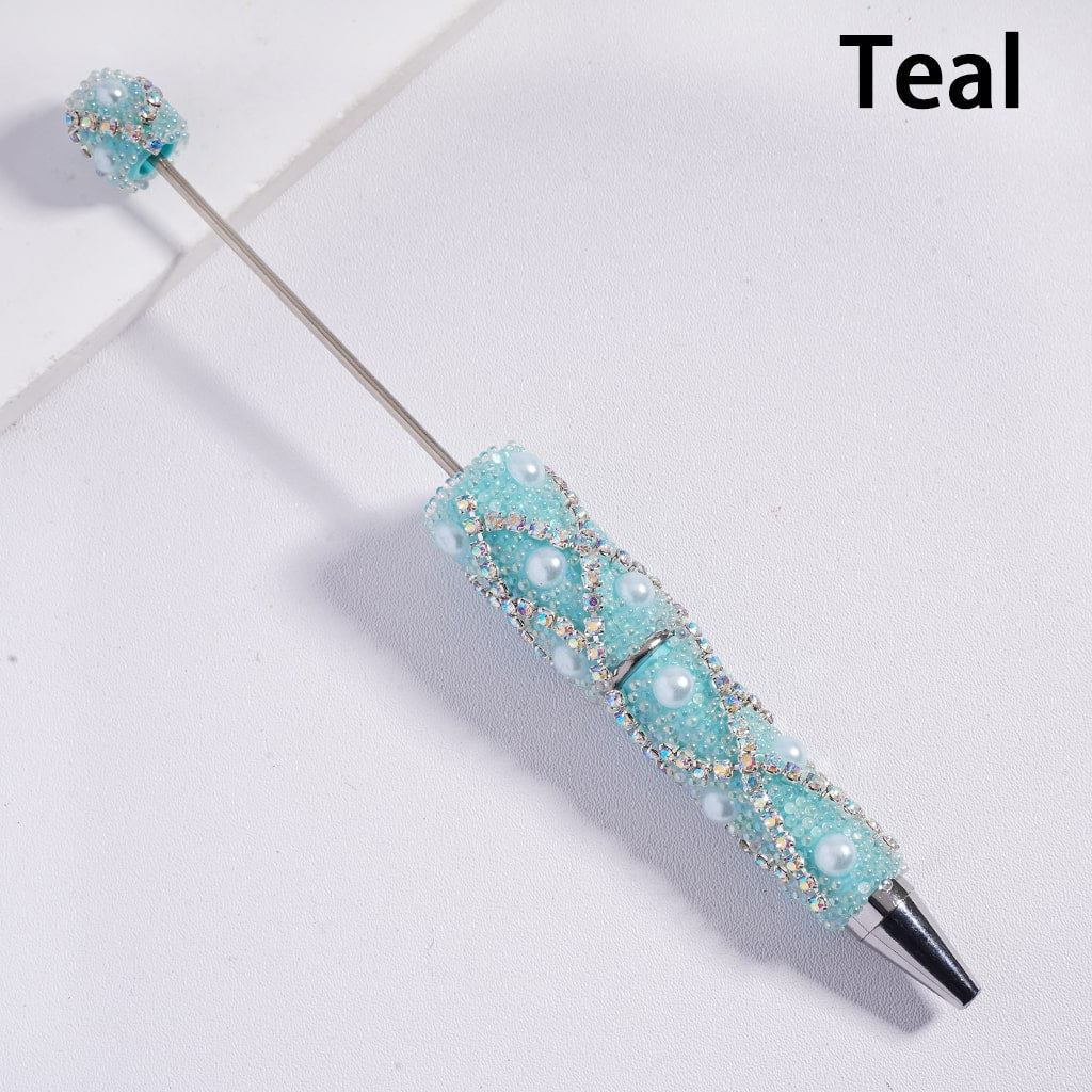 Teal decorative pen with gemstones on a light background