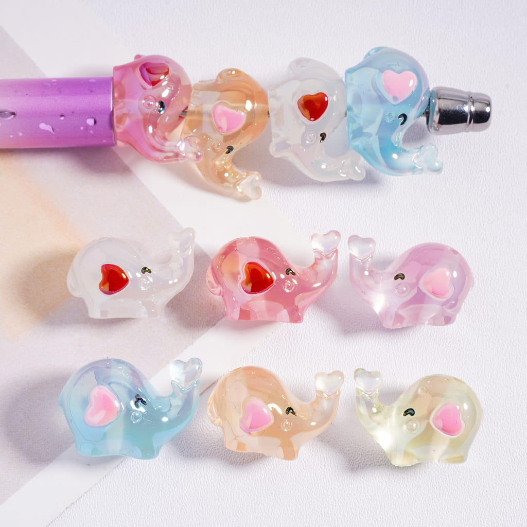 Colorful elephant-shaped hair ties on a white background