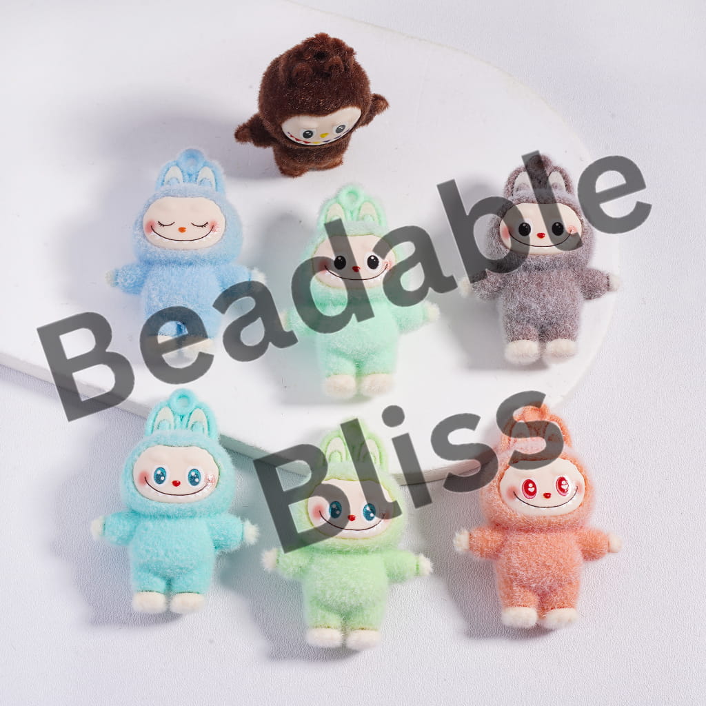 Colorful small plush toys in various costumes on a white background with 'beadablebliss.com' branding.

