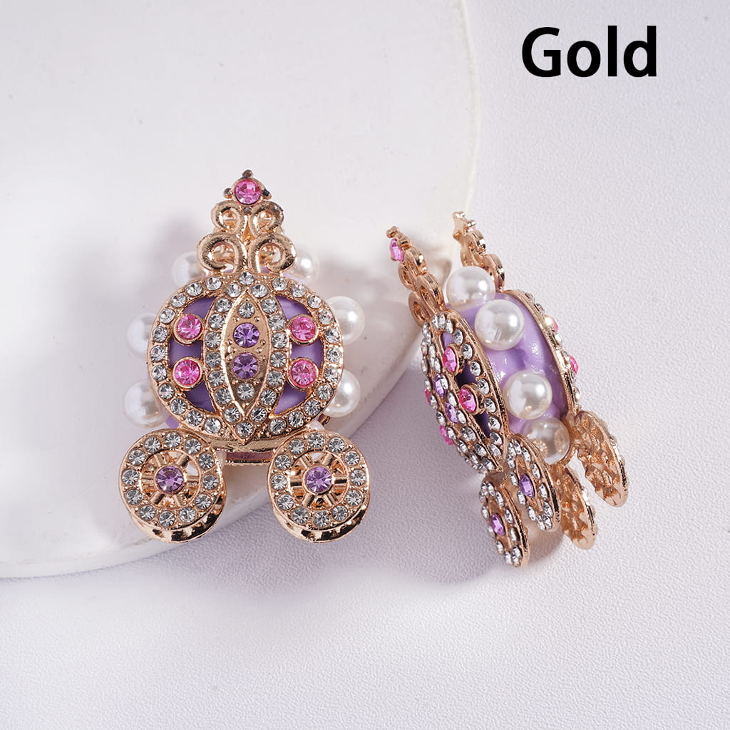 Gold earrings with purple and pink gemstones on a white background
