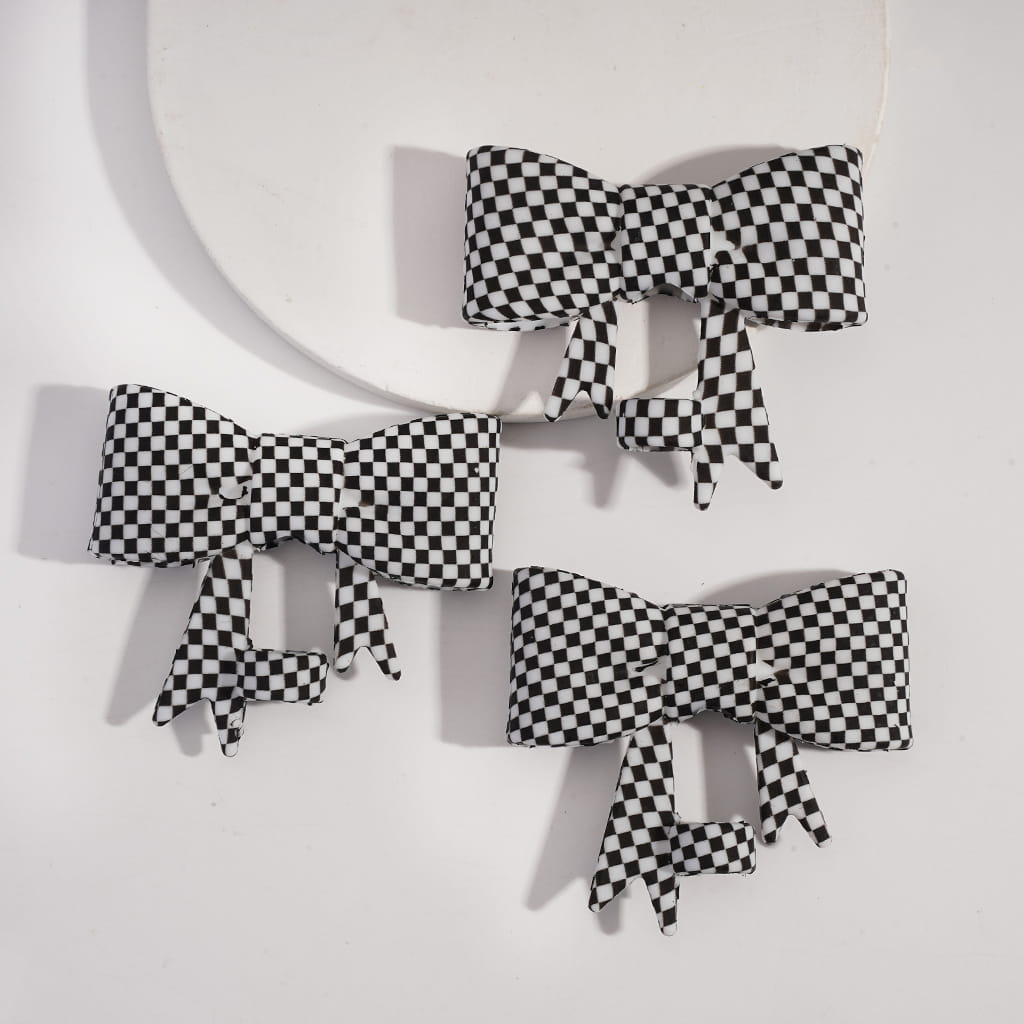 Black and white checkered bows on a white background