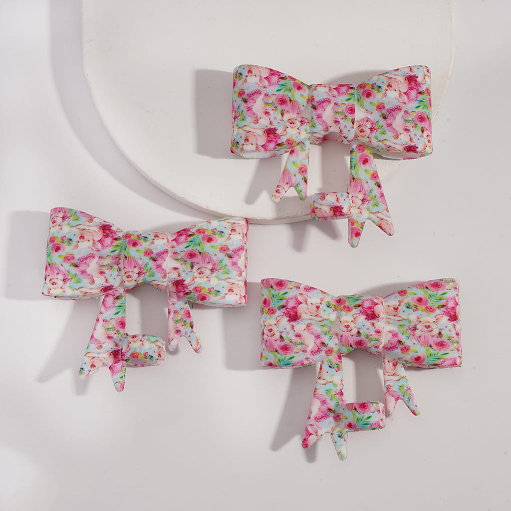 Three floral-patterned hair bows on a white background