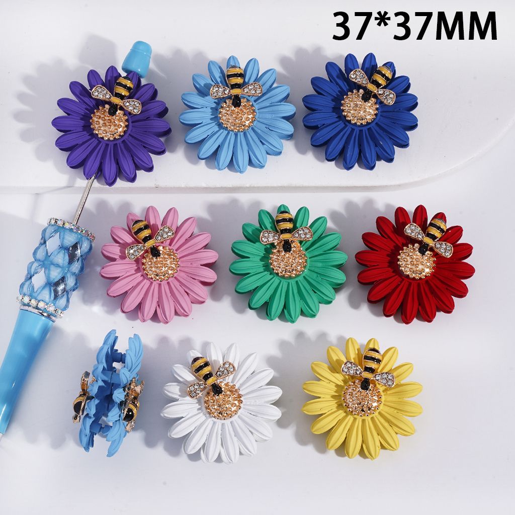 Colorful flower-shaped hair clips with bee designs on a white background