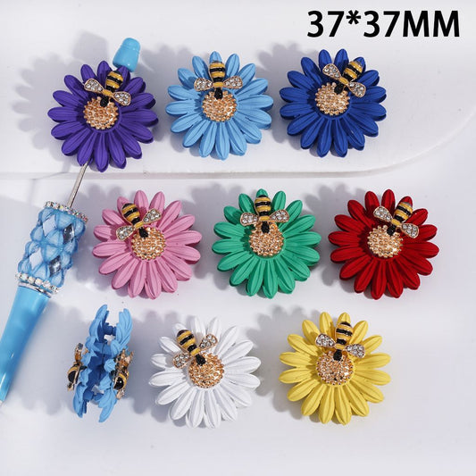 Colorful flower-shaped hair clips with bee designs on a white background
