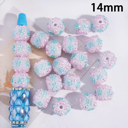 Decorative beads with blue and pink colors on a white background
