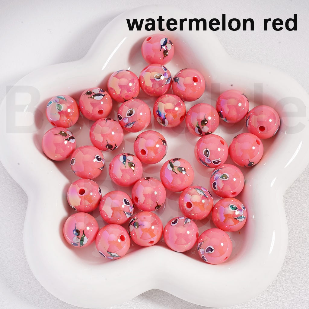Pink beads with watermelon red color on a white dish

