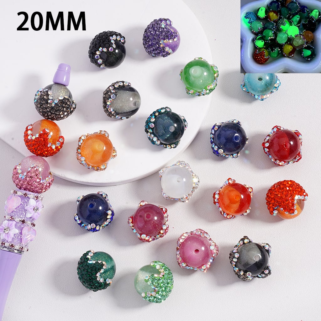 Colorful beads with glittery textures on a white surface, labeled '20MM'.