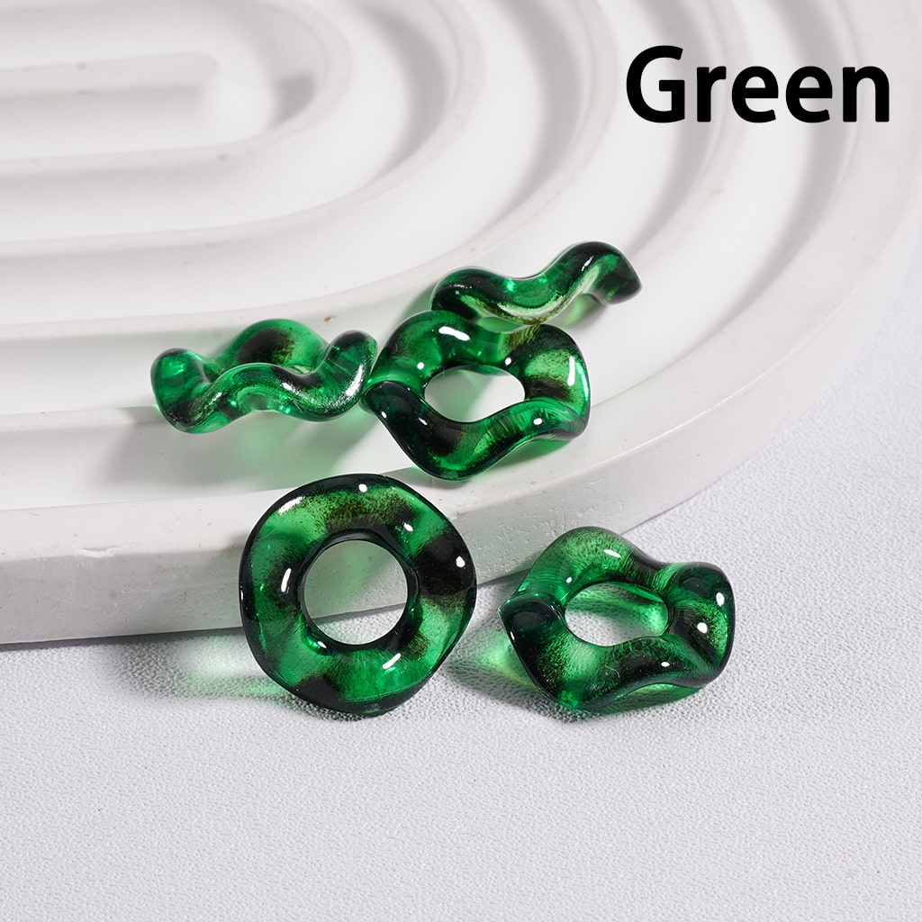 Green snake-shaped earrings on a white background

