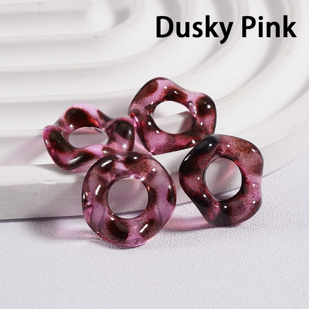 Dusty pink rings on a white fabric background with 'Dusky Pink' text.

