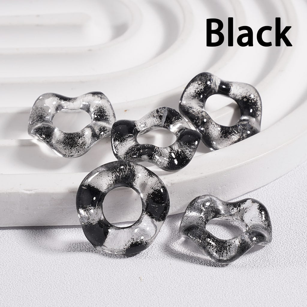 Black acrylic beads on a white background

