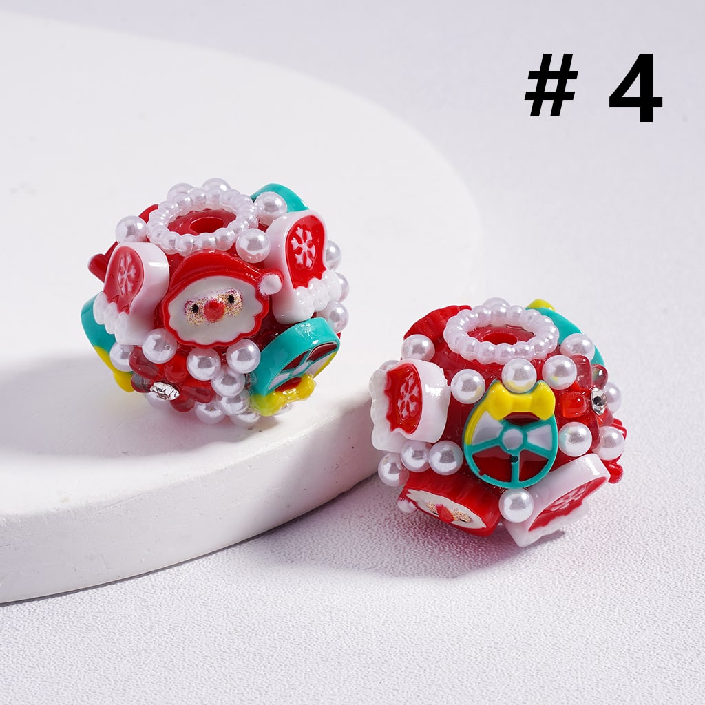 Colorful Christmas-themed earrings with Santa Claus design on a white background

