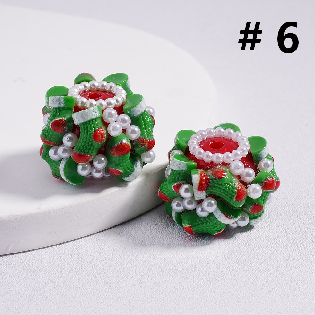 Pair of festive earrings with green, red, and white design on a light gray background.

