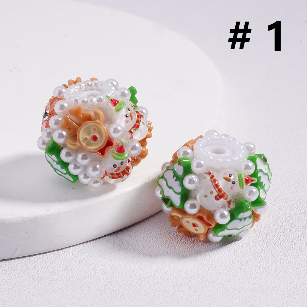 Decorative beads with snowman and flower designs on a white background

