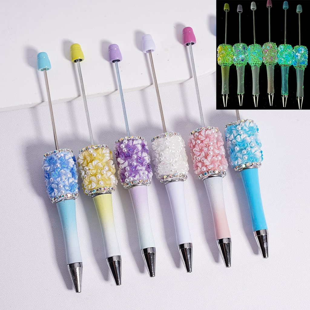 Colorful pens with decorative caps on a white background

