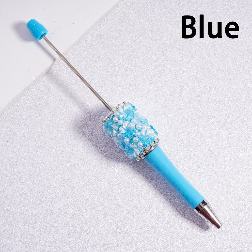 Blue pen with decorative cap on a light gray background


