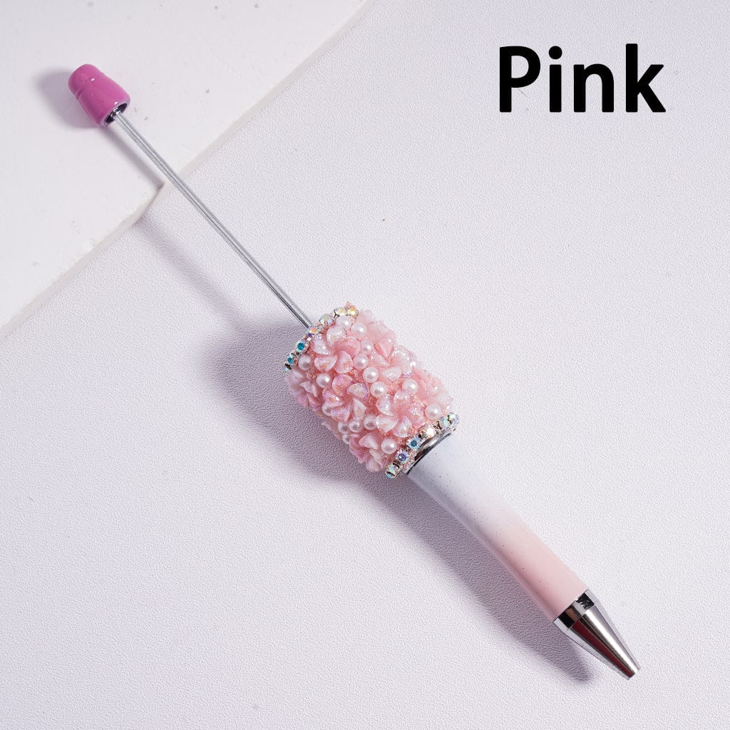 Pink pen with decorative cap on a light gray background

