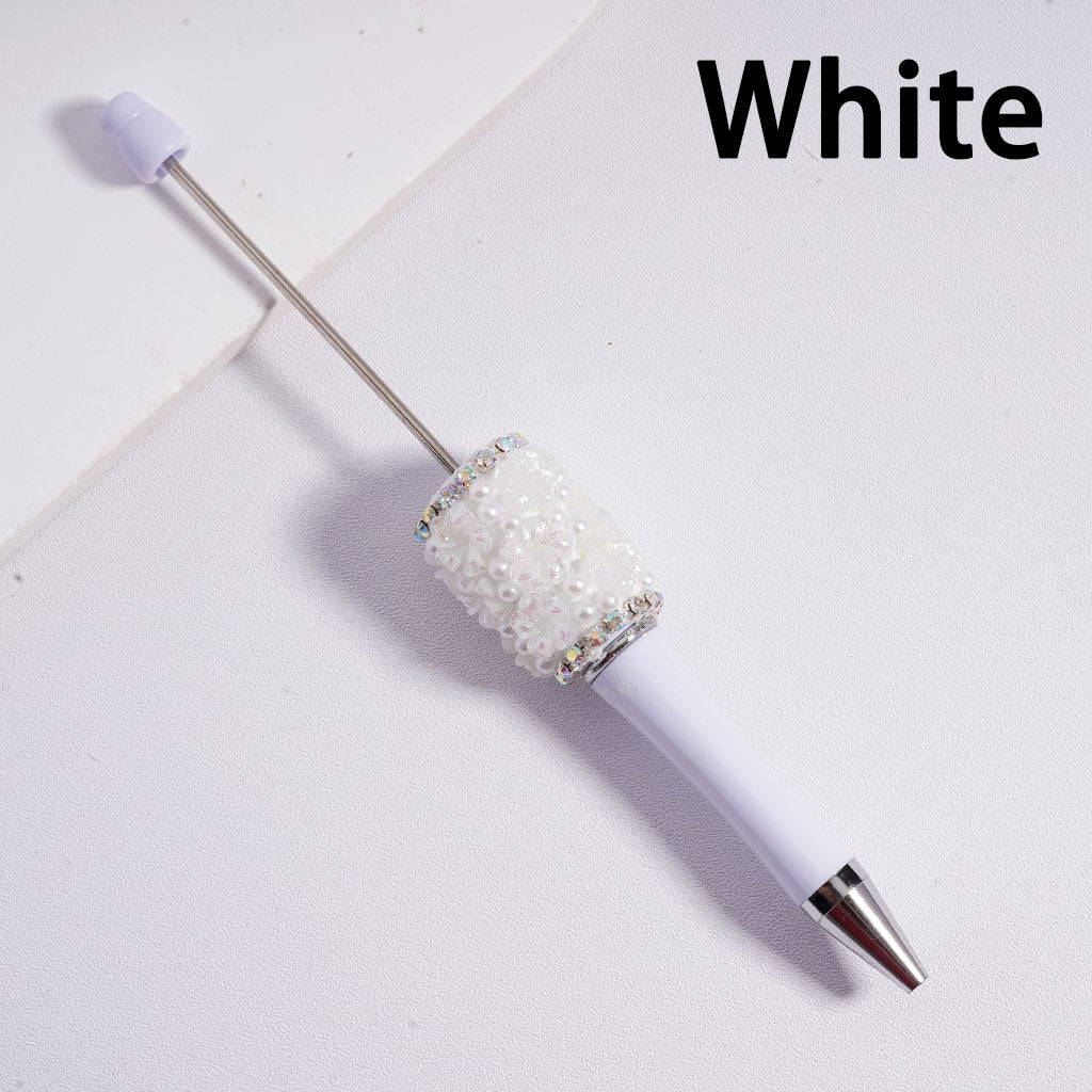 White pen with decorative cap on a light gray background


