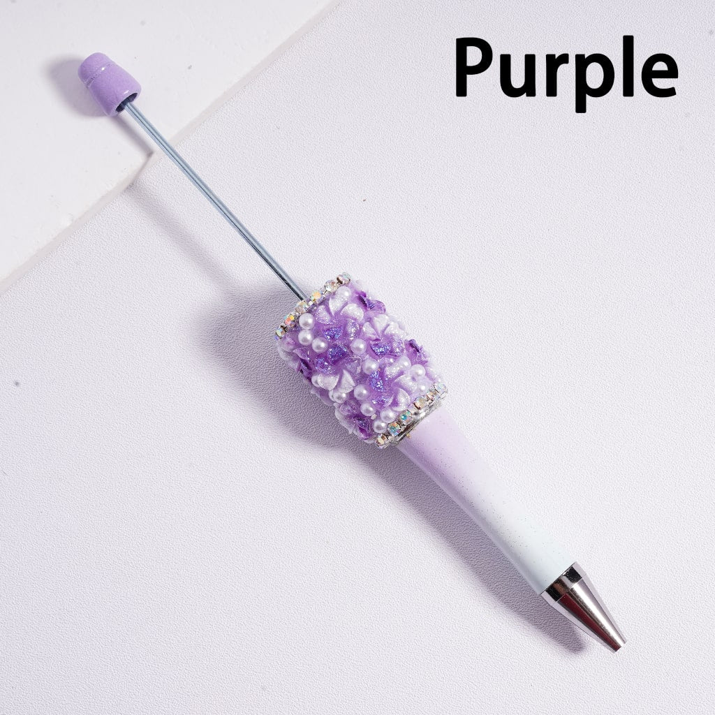 Purple pen with decorative top on a white background

