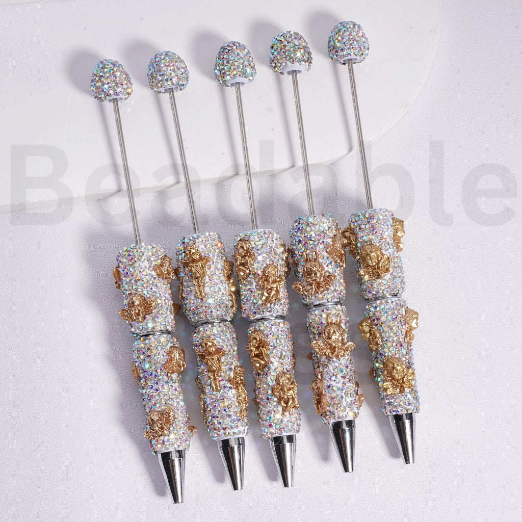 Decorative pens with gemstone accents on a white background, branded 'beadablebliss'.

