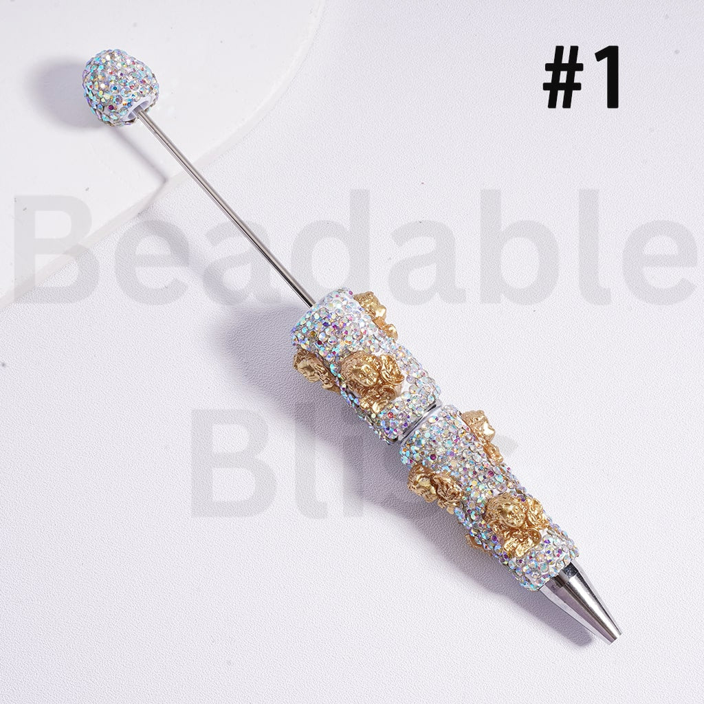 Decorative pen with gemstone accents on a white background, branded 'beadablebliss'.

