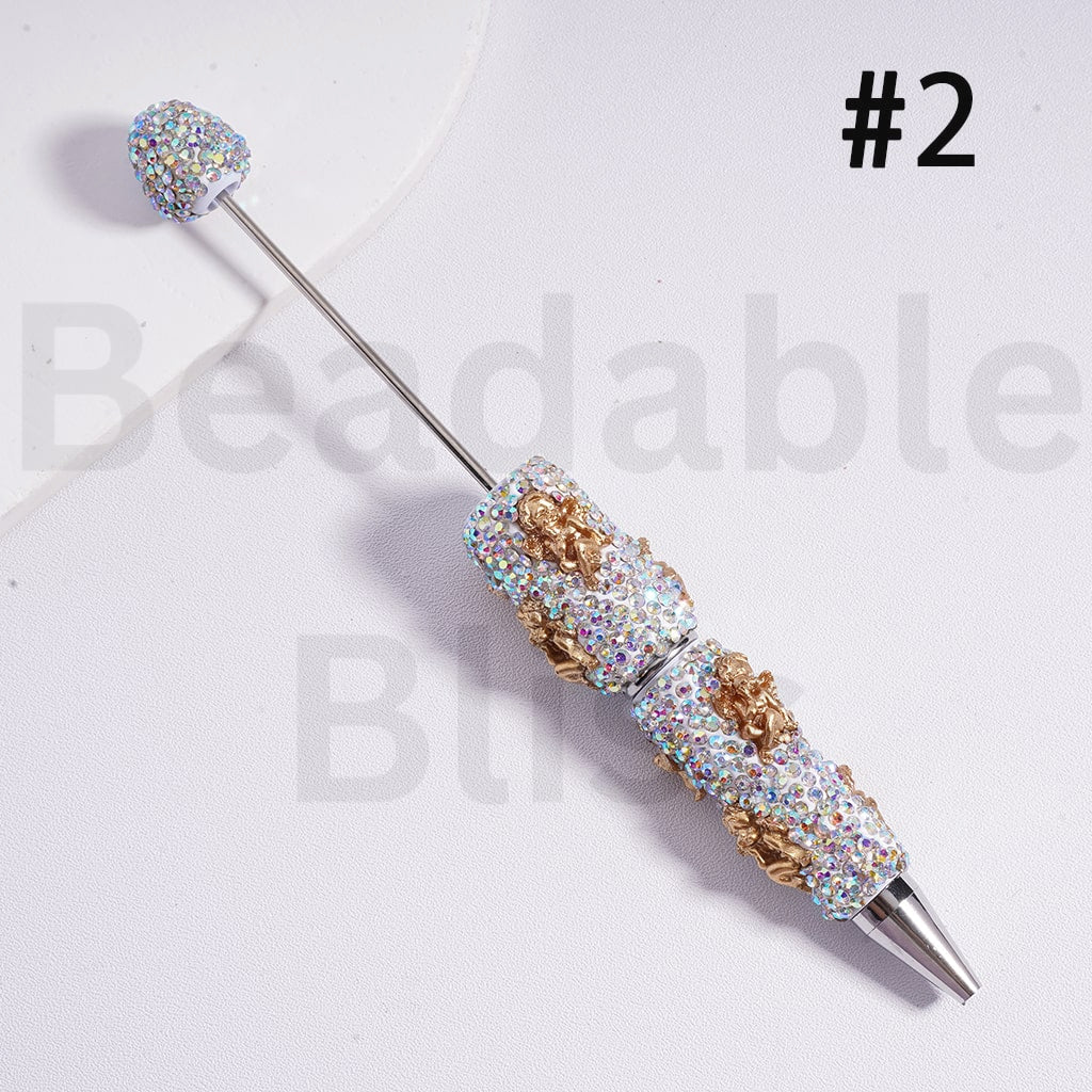 Decorative pen with gemstone accents on a white background, branded 'beadbablebliss'.

