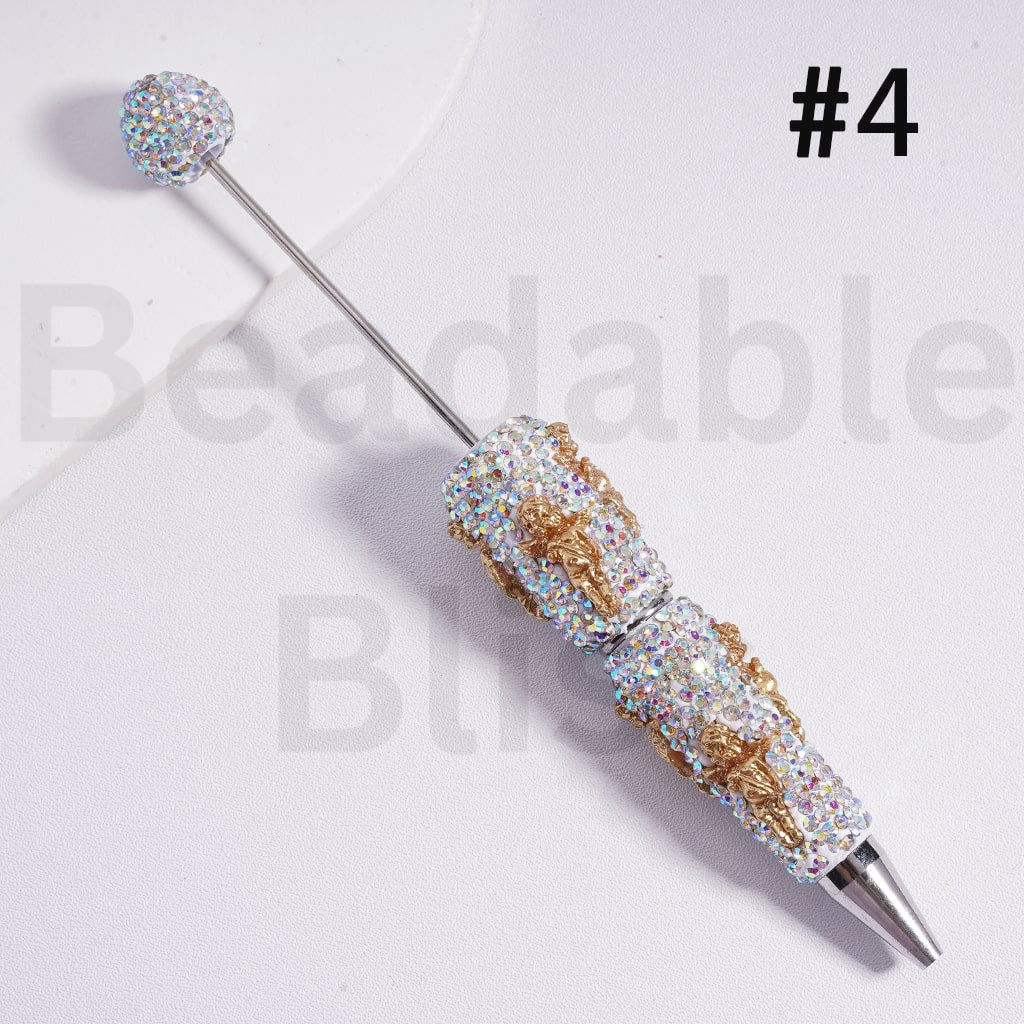 Decorative pen with gemstone accents on a white background, branded 'beadabblebliss'.

