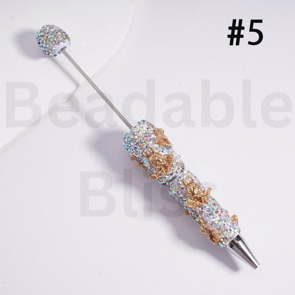 Decorative pen with gemstone accents on a white background, branded 'beadablebliss'.

