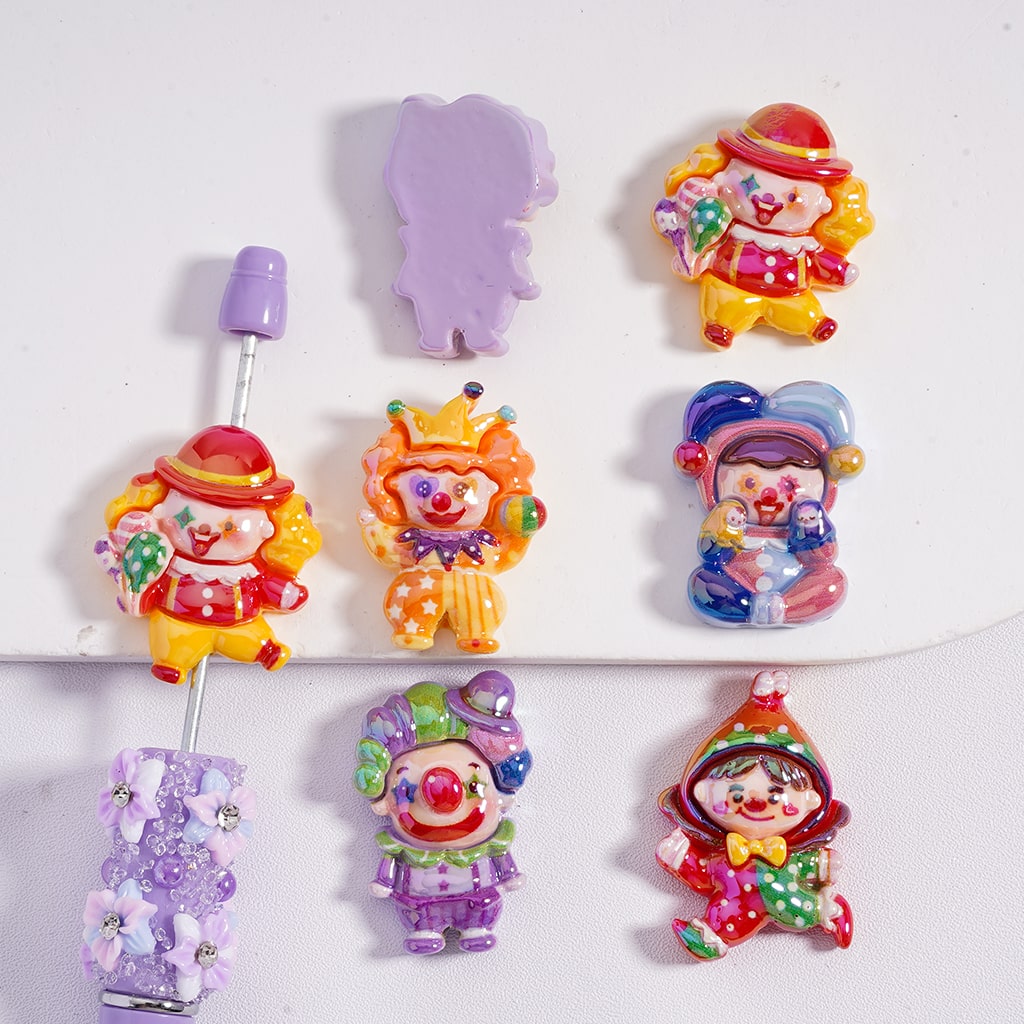 Colorful clown-shaped hair ties on a white background

