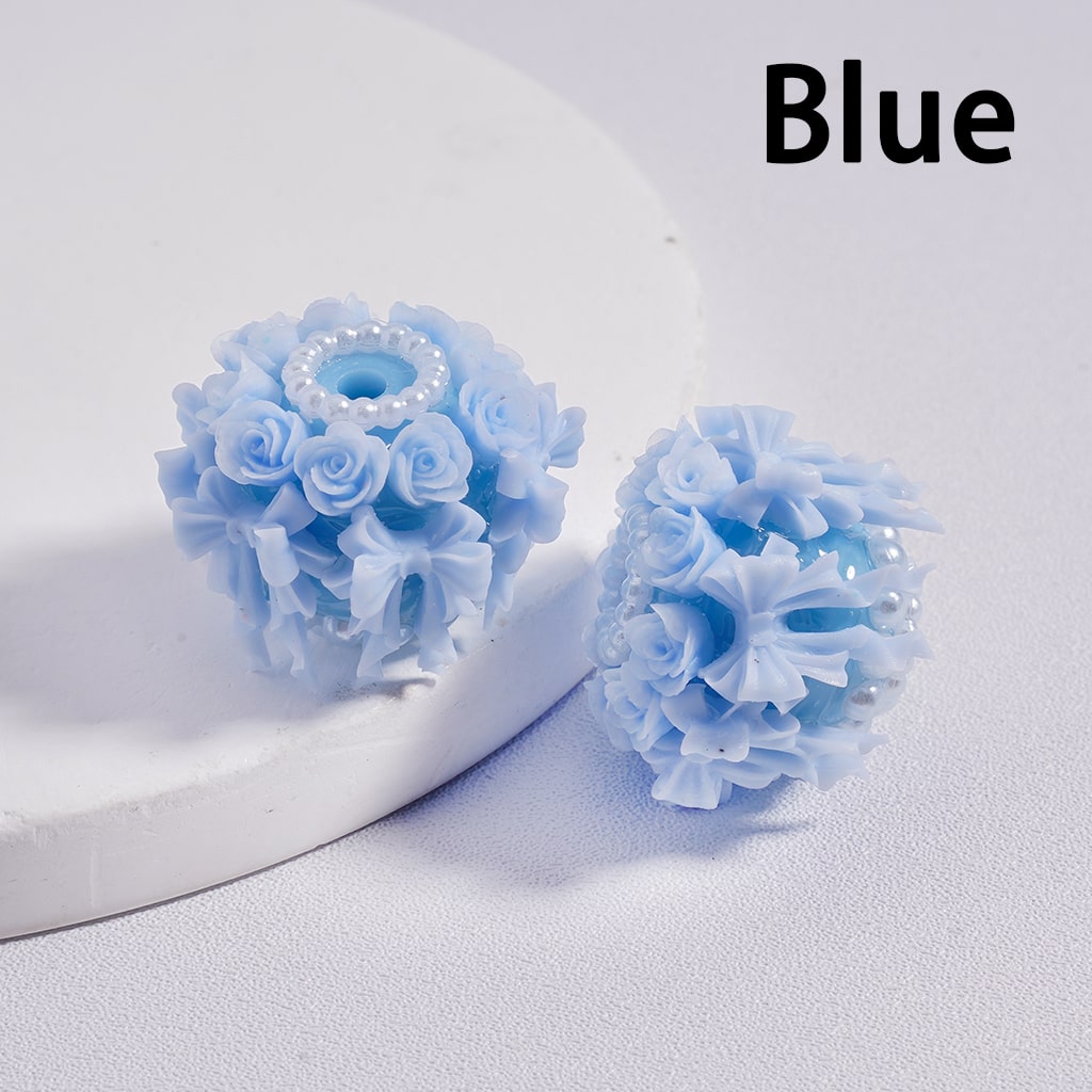 Blue floral earrings on a white background with 'Blue' text.

