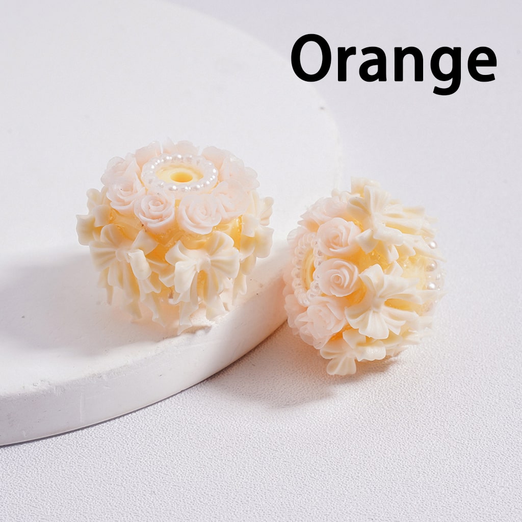 Orange flower-shaped bath bombs on a white surface with 'Orange' text above.


