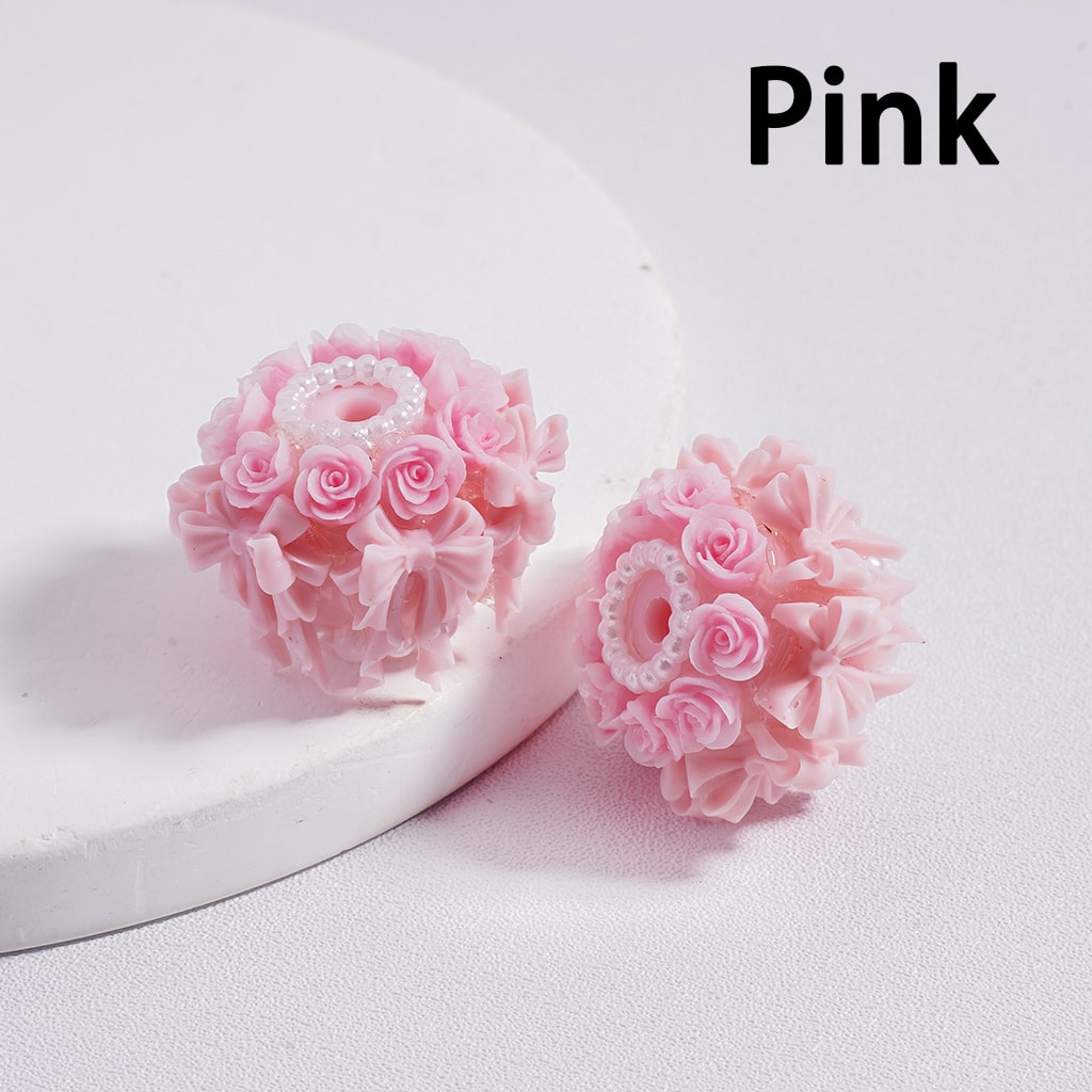 Pink floral earrings on a white background with 'Pink' text.

