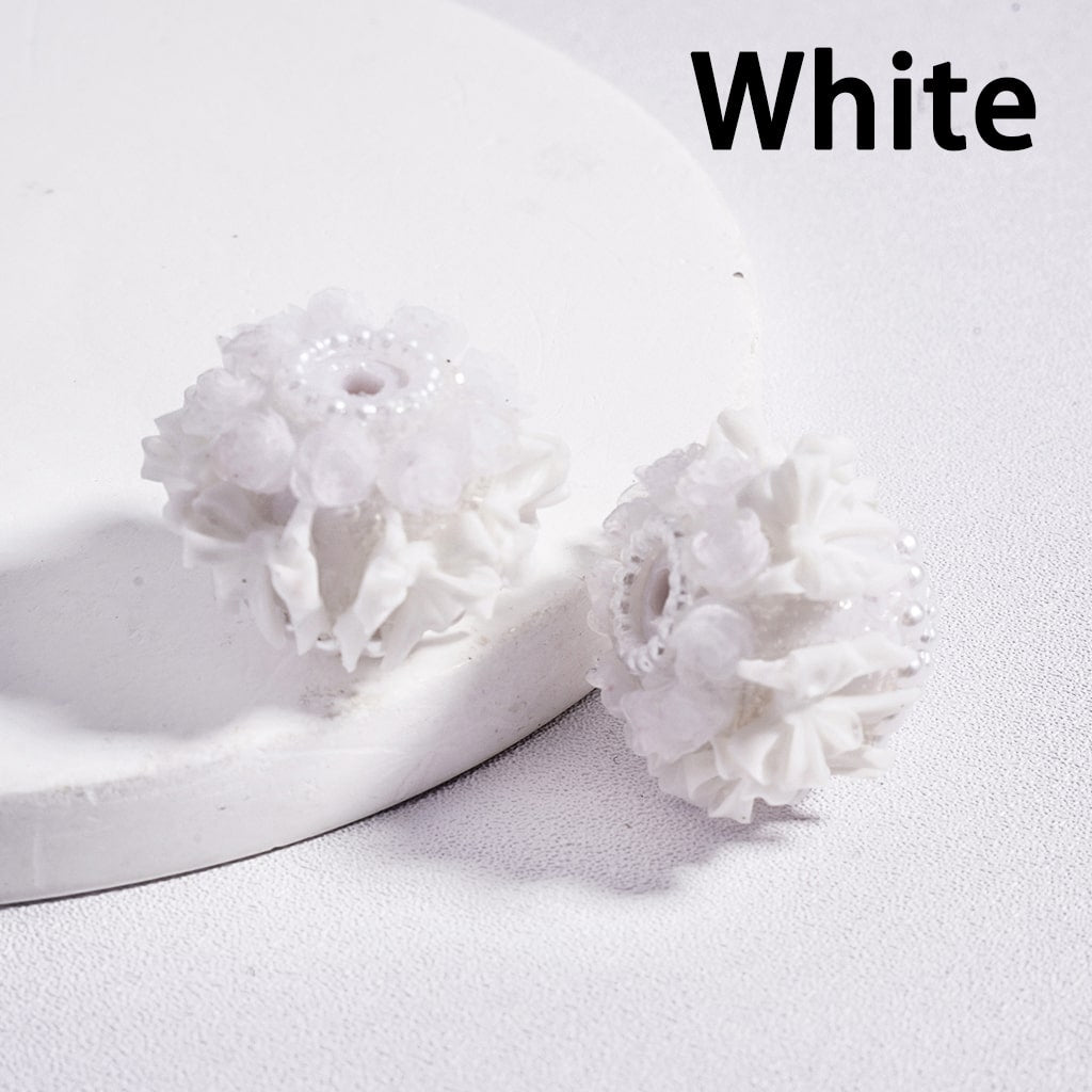 White floral earrings on a white background with 'White' text above.

