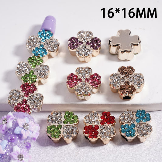 Colorful flower-shaped beads with rhinestones on a white background

