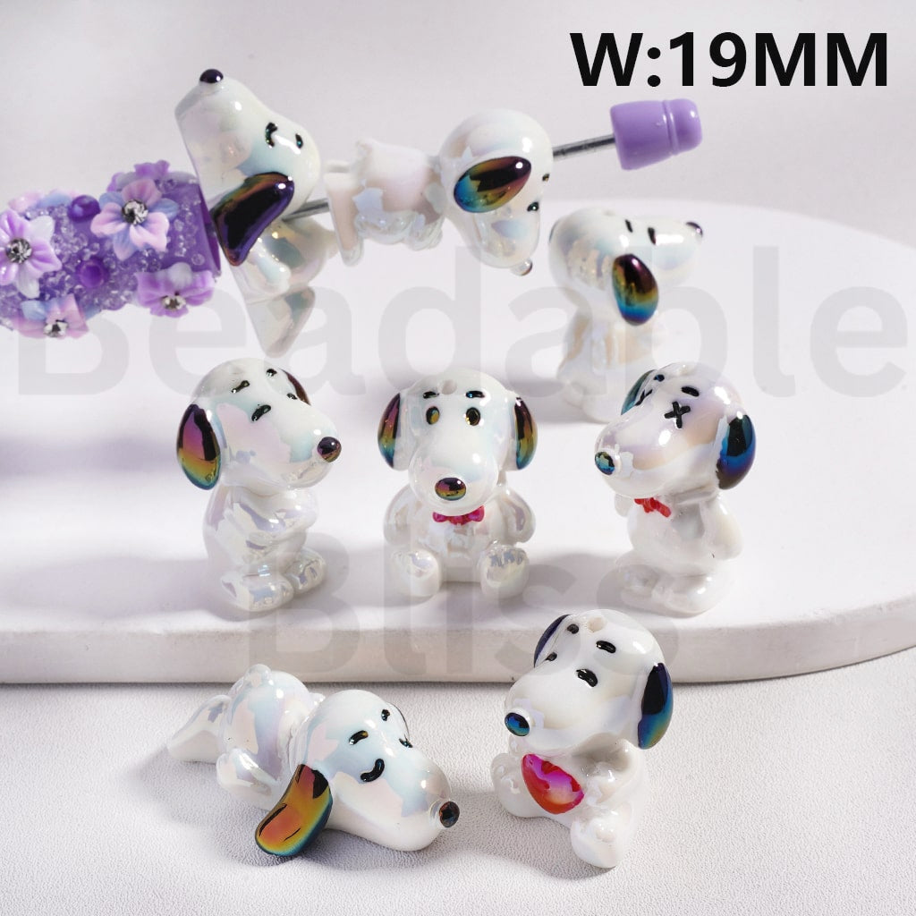 Set of small dog figurines with colorful accents on a white background

