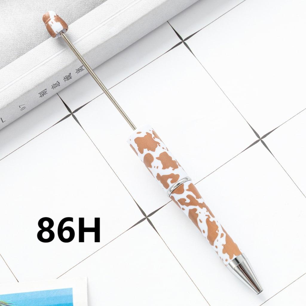 Pen with cow print design on a tiled floor
