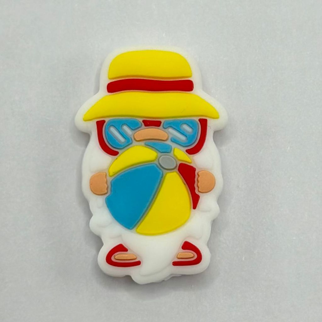 A silicone bead featuring a whimsical gnome character wearing sunglasses and holding a beach ball.

