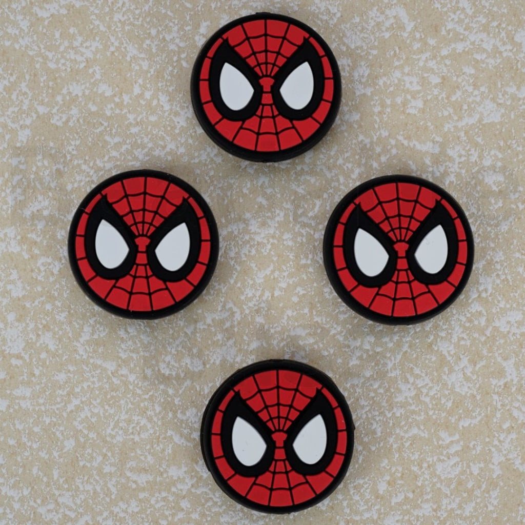 Four Spider-Man emblem patches on a textured beige background

