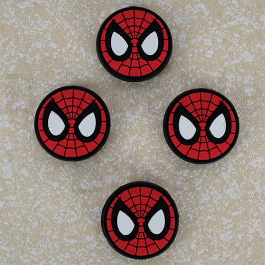 Four Spider-Man emblem patches on a textured beige background

