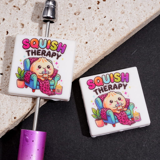 Cute Steamed Dumplings Relaxing on Chair Holding Drink with “SQUISH THERAPY” Text Flat Square Silicone Focal Beads