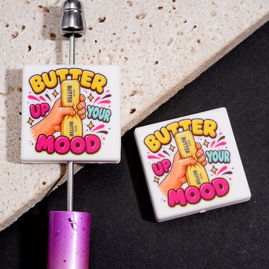 Adorable Hand Holding Butter Stick with “BUTTER UP YOUR MOOD” Text Flat Square Silicone Focal Beads