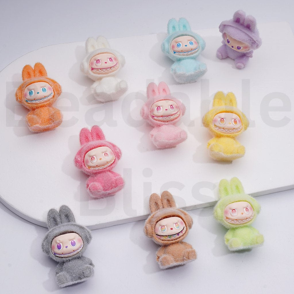 Colorful plush toys with cartoon faces on a white background

