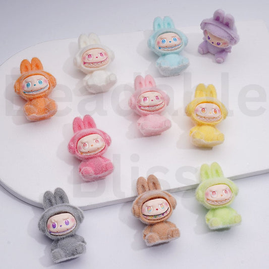 Colorful plush toys with cartoon faces on a white background


