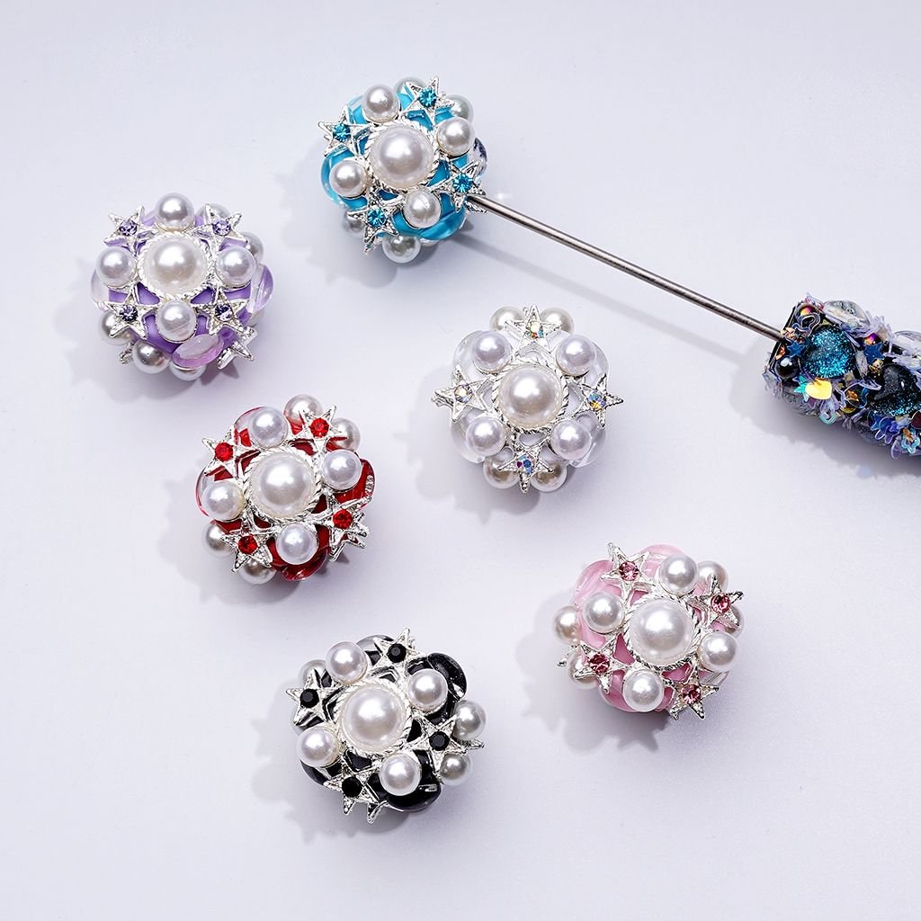 A collection of silver alloy stars with various colors of rhinestones and pearls, designed for use in beadable pens.

