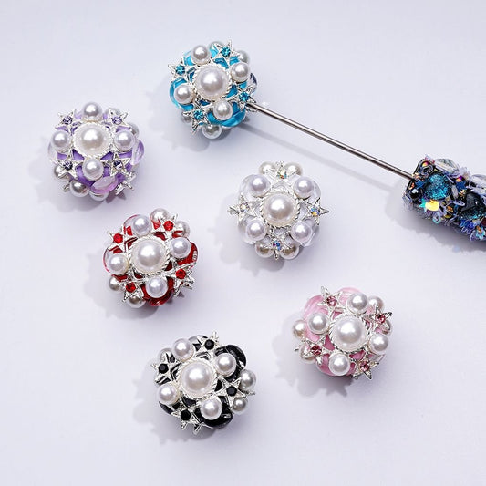 A collection of silver alloy stars with various colors of rhinestones and pearls, designed for use in beadable pens.

