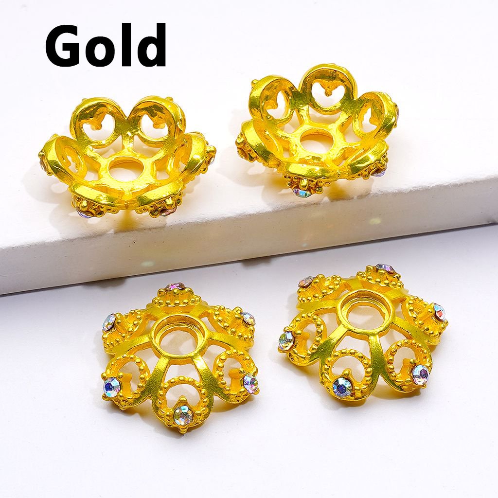 Gold earrings with intricate designs on a white background

