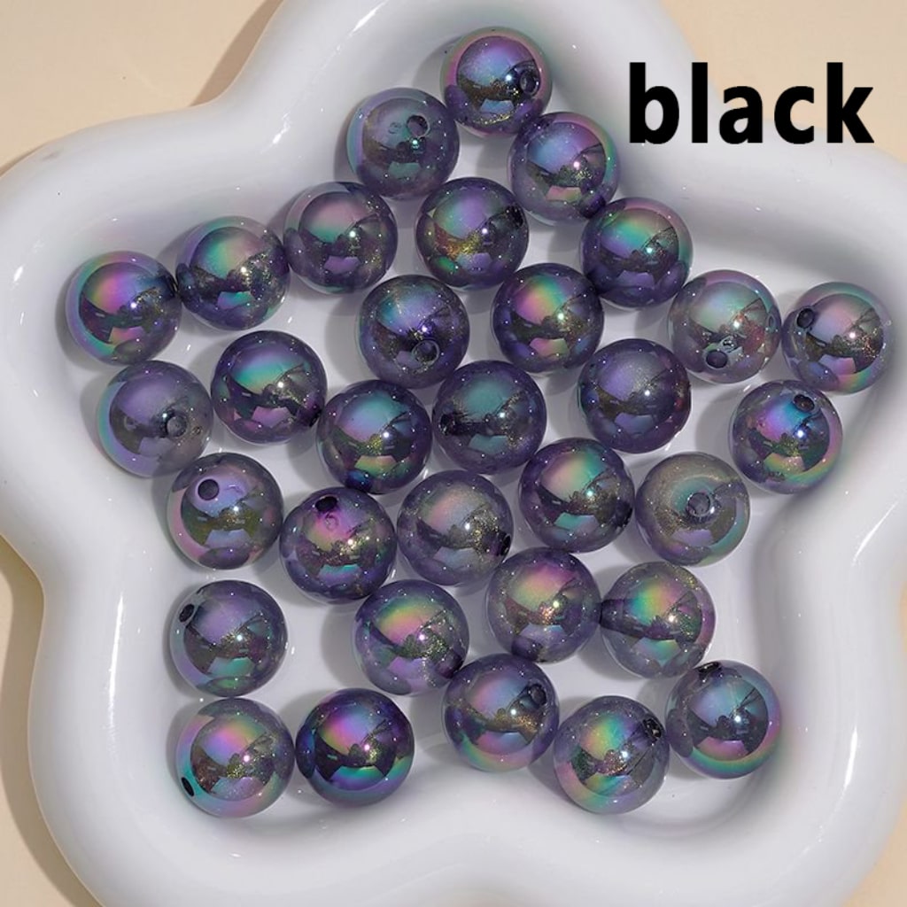Iridescent beads on a white dish with 'black' text overlay

